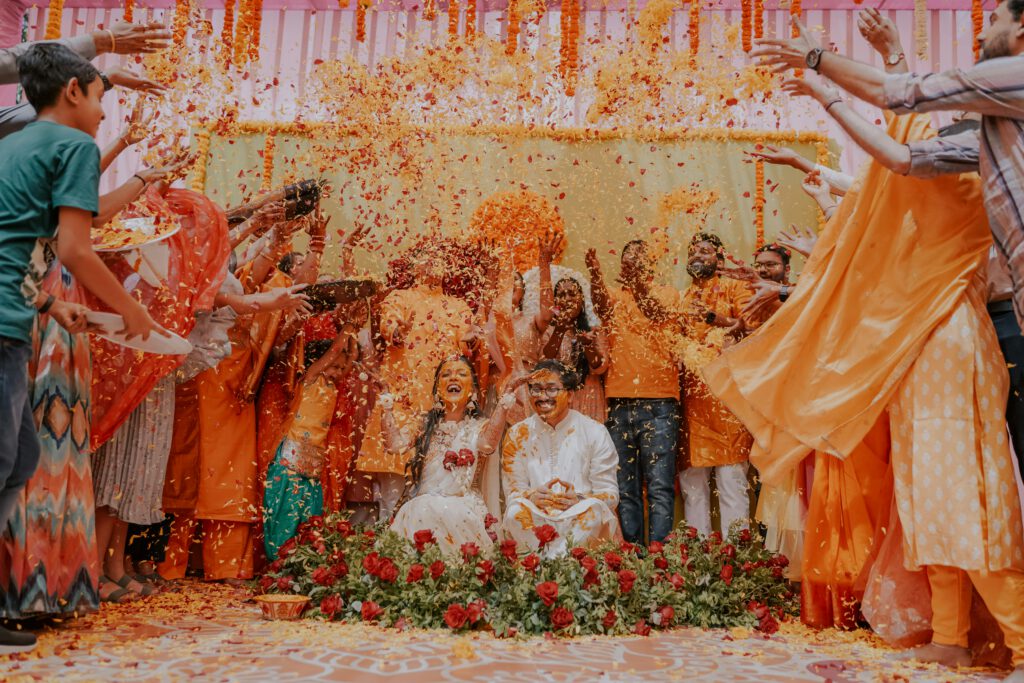 Joyous Indian wedding ceremony with vibrant colors and flower petal tossing.
