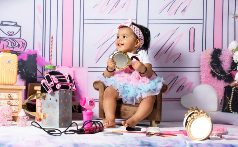 Charming baby girl enjoying playful indoor setup with toys and colorful decor.